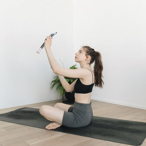 A person stretching peacefully in a calm, modern environment.